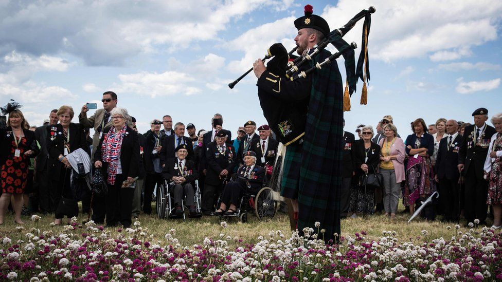 A British soldier played the bagpipes for the inauguration of a garden in Arromanches