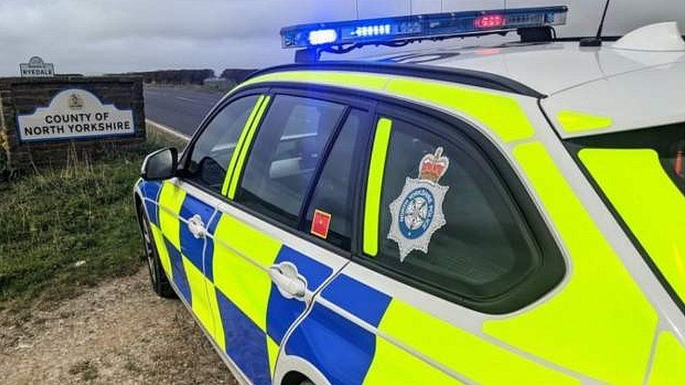 Image of a police car and a North Yorkshire sign in the background