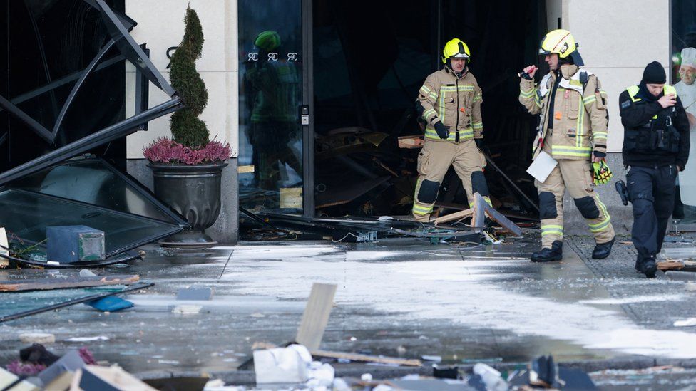 Firefighters at the scene of the incident in Berlin walking out through the rubble