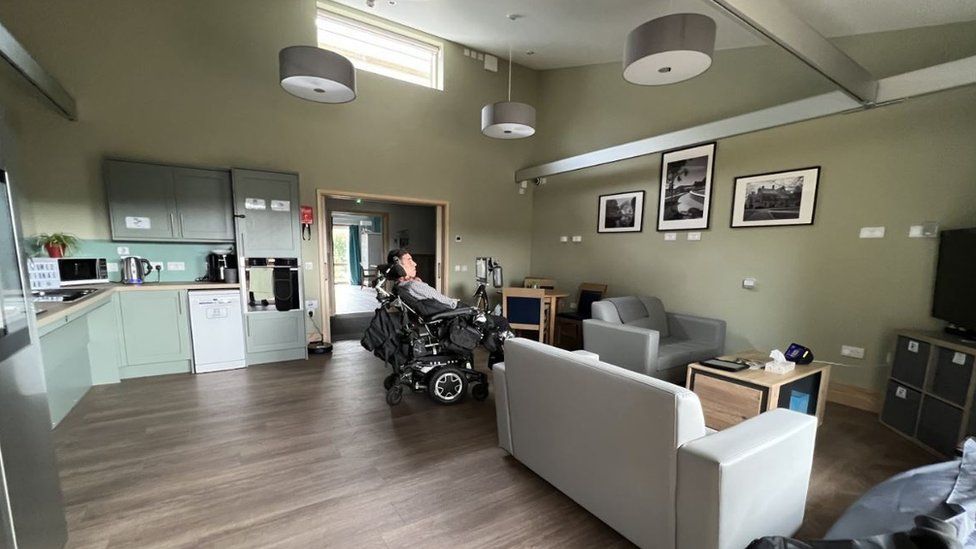 A picture of Jasper's room at college. There are smart devices and enough room for his wheelchair to move around the room.