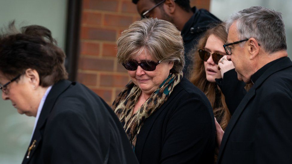 Julia Amess (centre) the widow of Conservative MP Sir David Amess, accompanied by the Rev Clifford Newman (right) of Belfairs Methodist Church, during a visit to view flowers and tributes left for her late husband at the church in Eastwood Road North, Leigh-on-Sea, Essex, where he died after being stabbed several times during a constituency surgery on Friday.