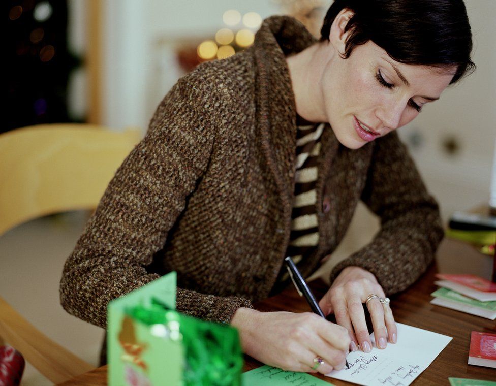 Woman writing Christmas cards