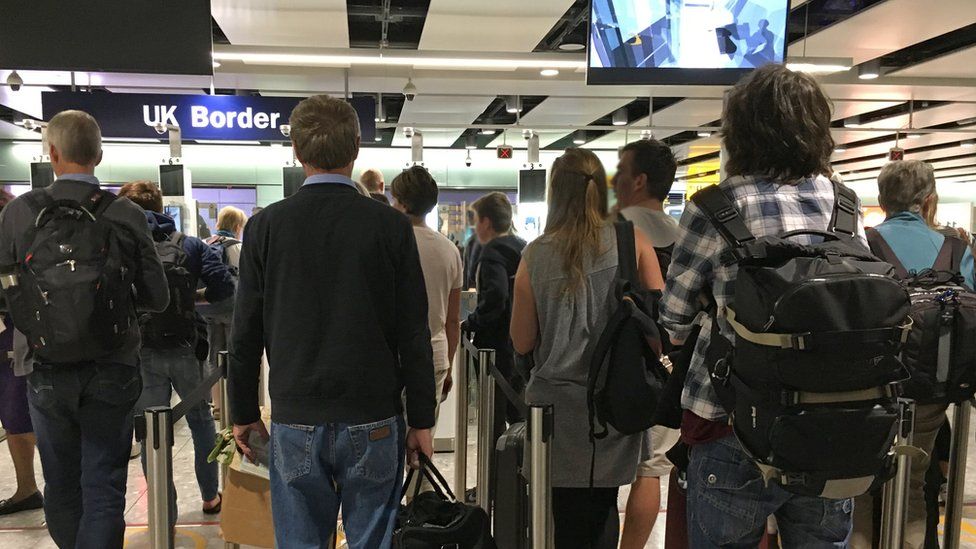 People queue for the biometric gates at Heathrow