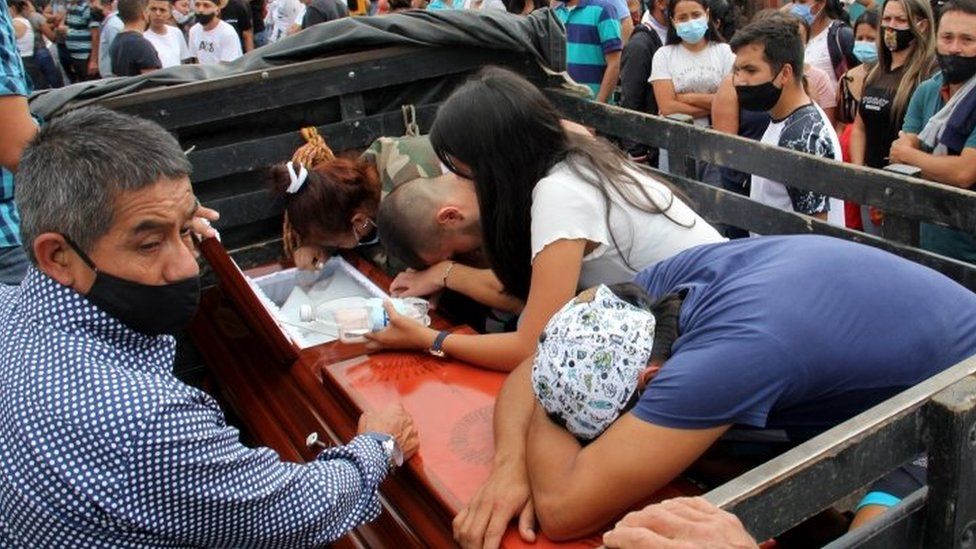 Family members bid farewell to one of the victims of the murder of eight people in Samaniego, Colombia, 16 August 2020.