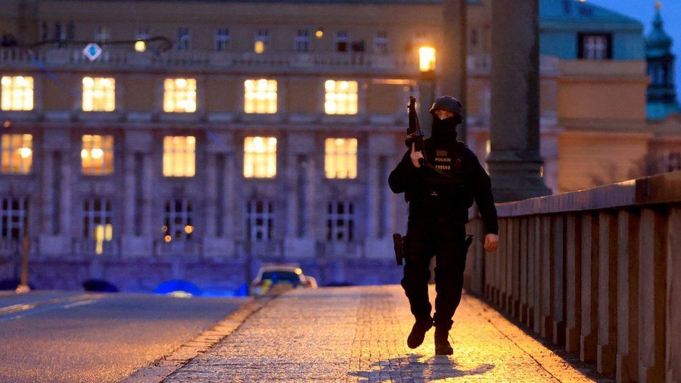 An armed police officer near the scene of the shooting in Prague. Photo: 21 December 2023