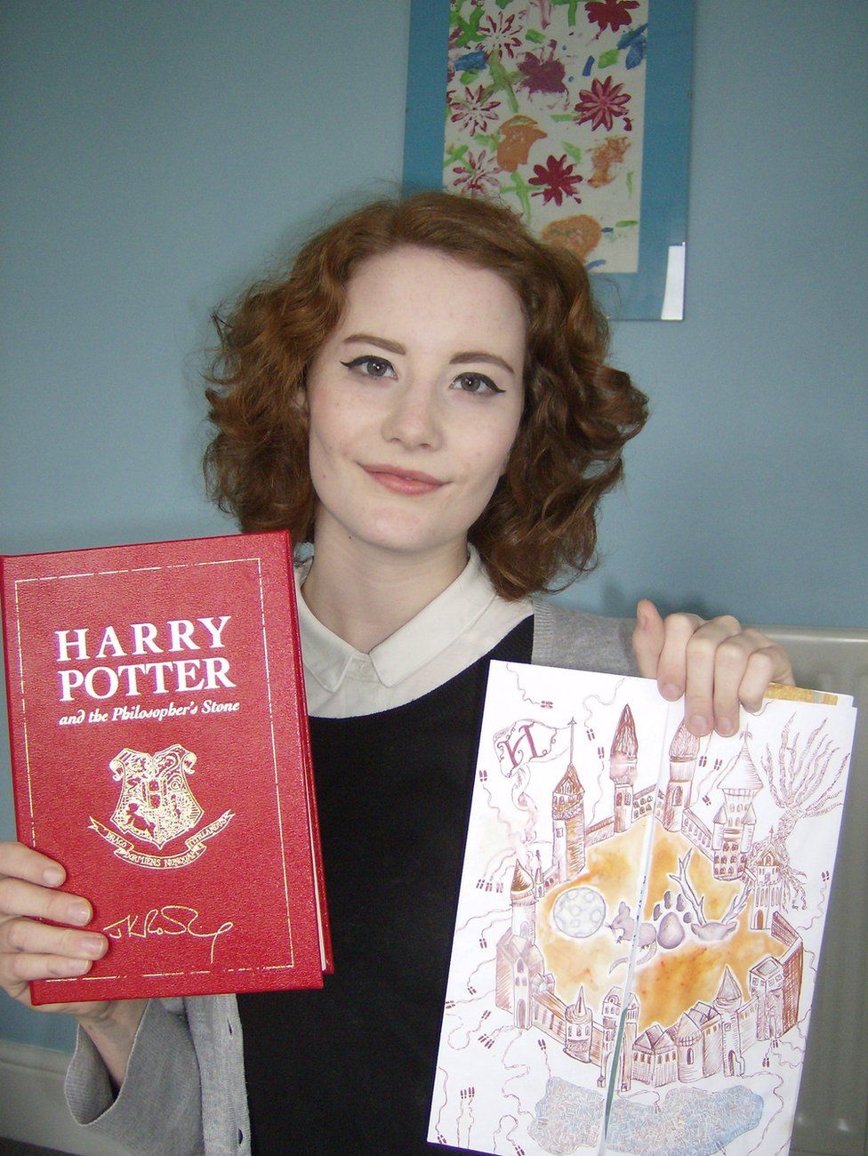 Chloe Esslemont holding the book and her colourful competition letter