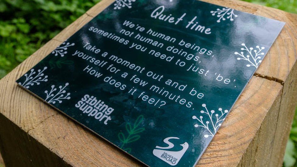 Signpost for the walk with advice about 'taking a moment'