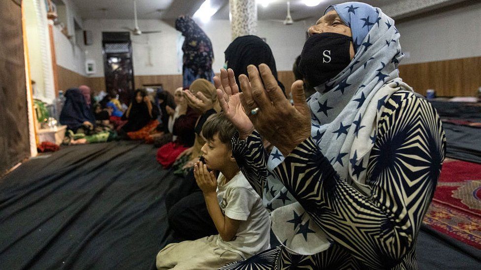 Displaced Afghan women and children from Kunduz pray at a mosque that is sheltering them on August 13, 2021 in Kabul