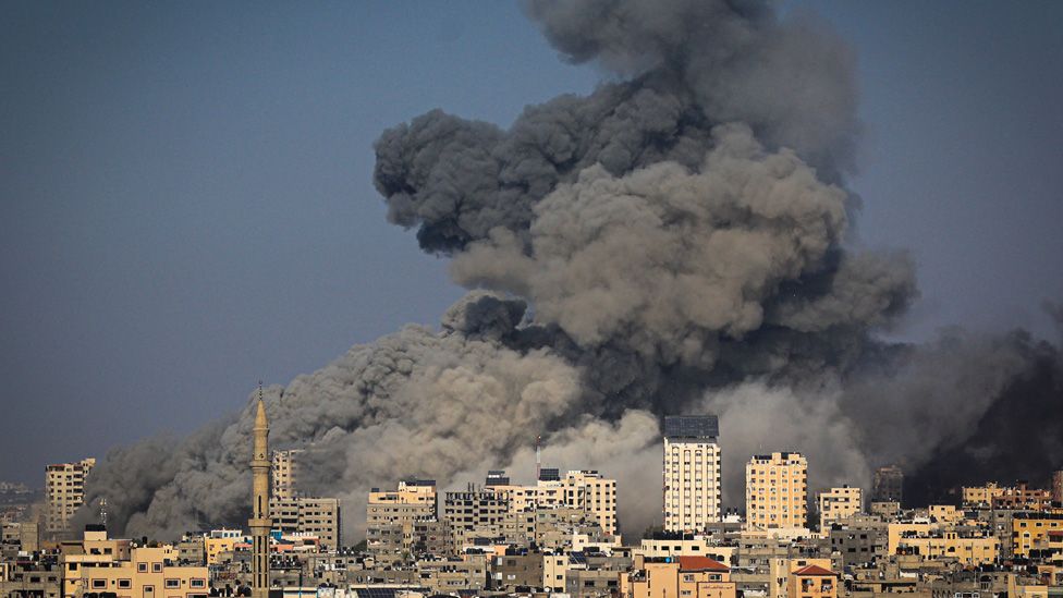 Smoke billows during Israeli air strikes in Gaza City on October 12