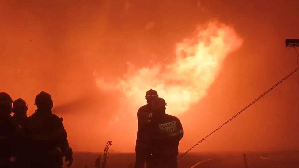 Firefighters work to extinguish a fire, in Hrensko, Czech Republic