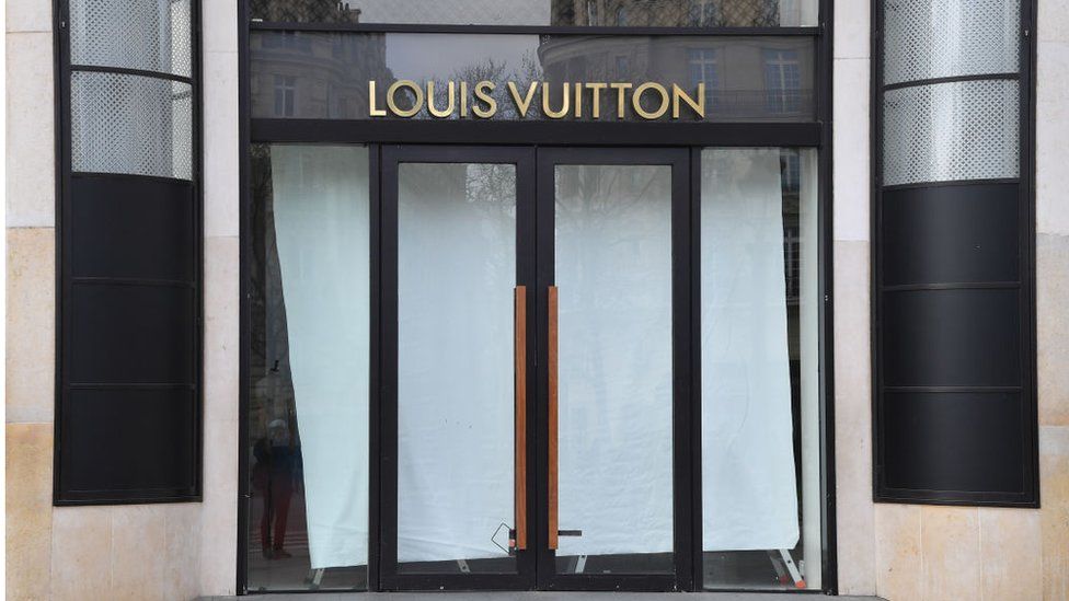 A closed Louis Vuitton shop is seen on the Champs Elysees.
