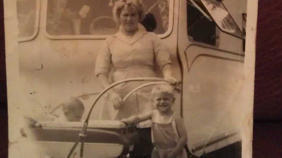 Larry as a young child with mum and brother outside their caravan