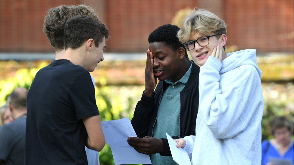 Laurence Herring (right) and Gerald Ikazoboh (centre right) with their GCSE results at Norwich School in Norwich, Norfolk.