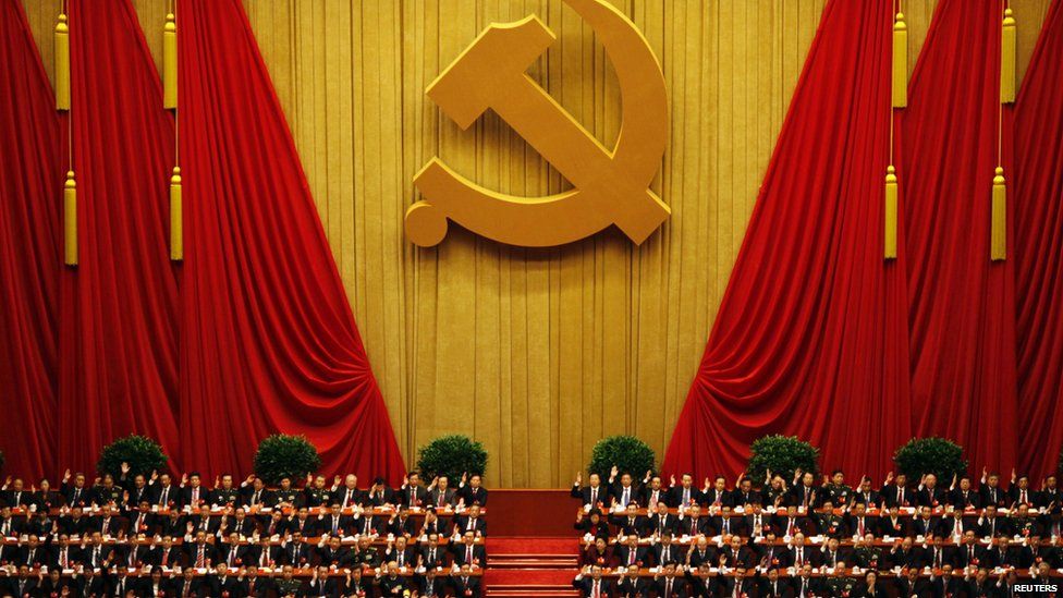 Delegates raise their hands as they take a vote during the closing session of the 18th National Congress of the Communist Party of China at the Great Hall of the People in Beijing, in this 2013 file photo