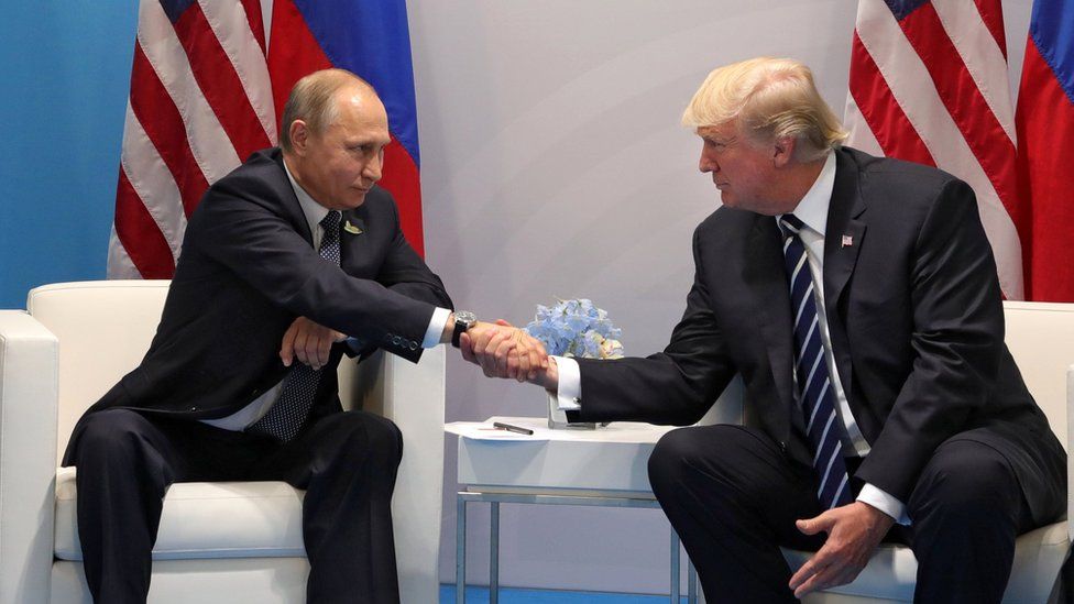 Russian President Vladimir Putin (L) and US President Donald Trump (R) shake hands during their meeting on the sidelines of the G20 summit in Hamburg, Germany (7 July 2017)