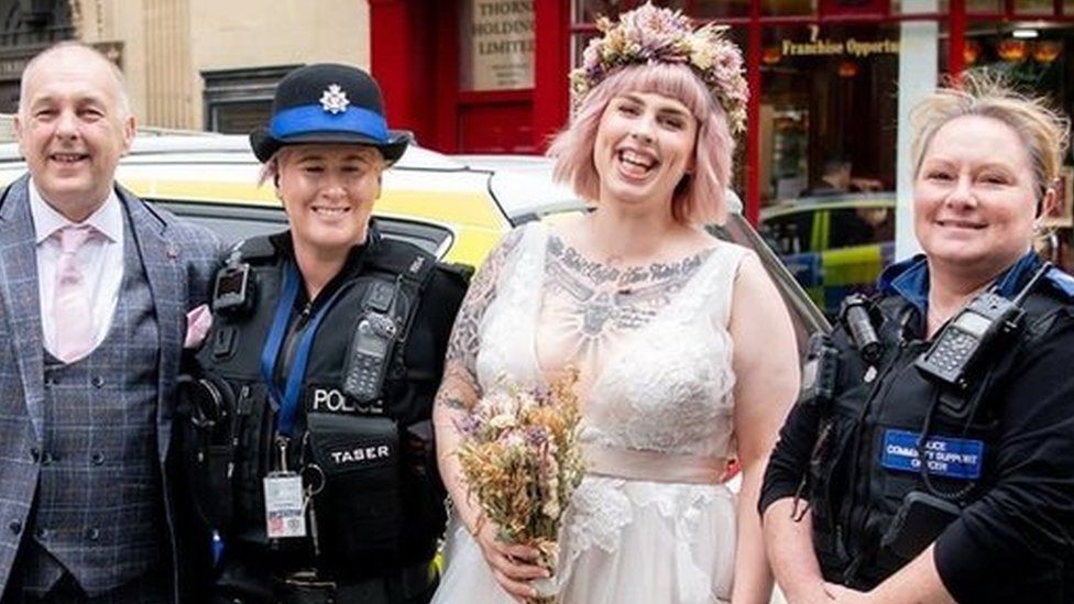 Yasmin Lovekin in wedding dress with father Colin, PC Griffiths and PCSO Turner