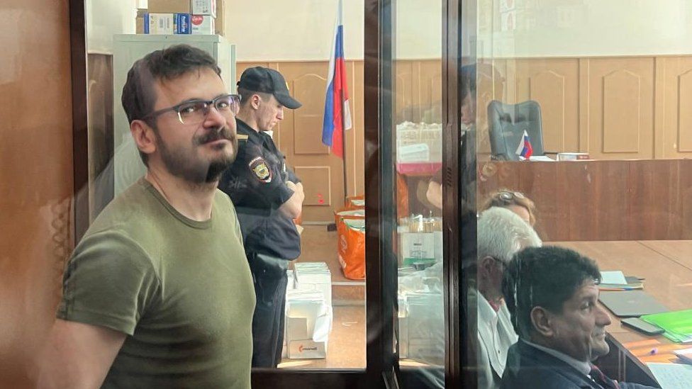 Russian opposition politician Ilya Yashin attends a court hearing in Moscow