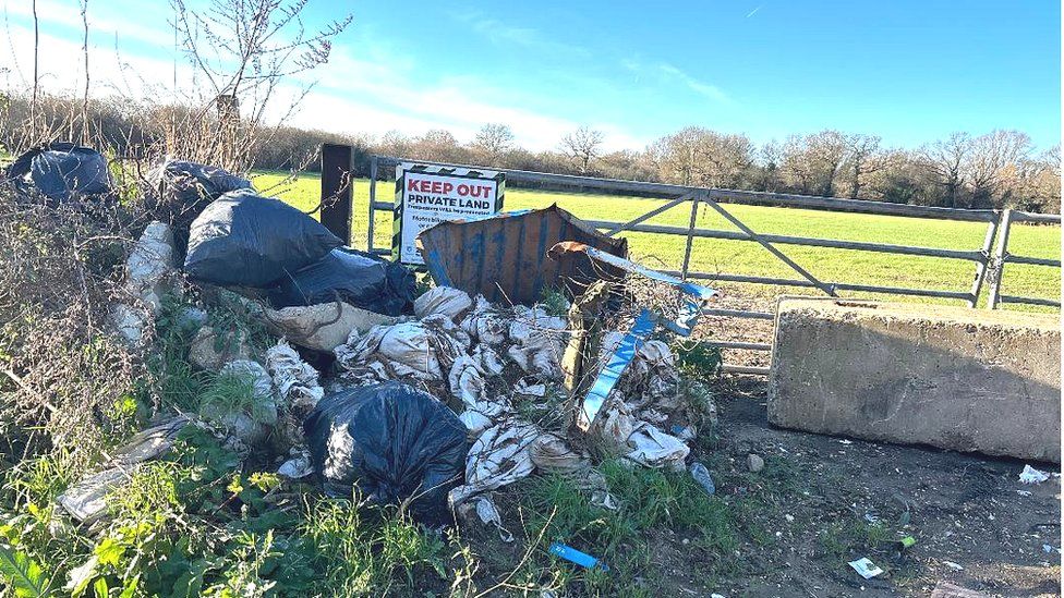 Rubbish outside farm land