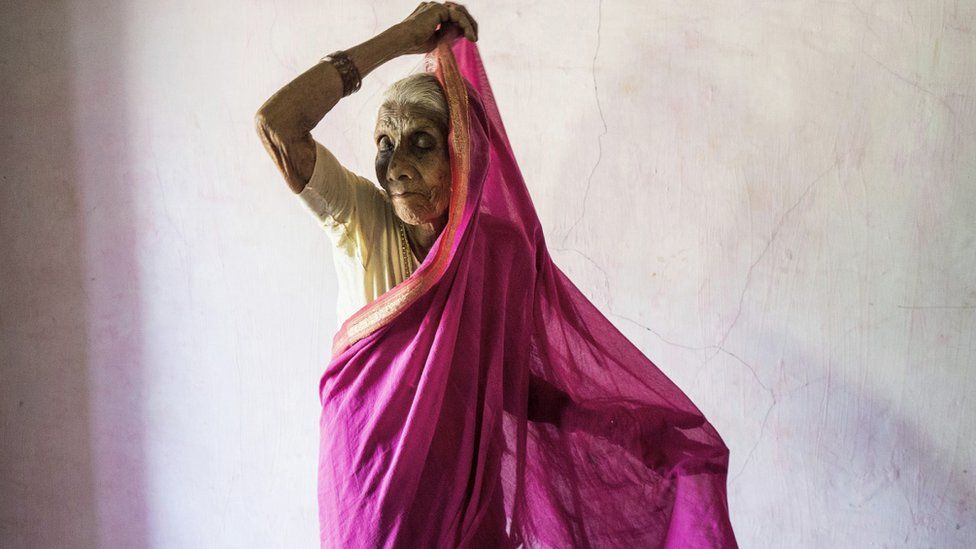 Ansuya Deshmukh putting on sari