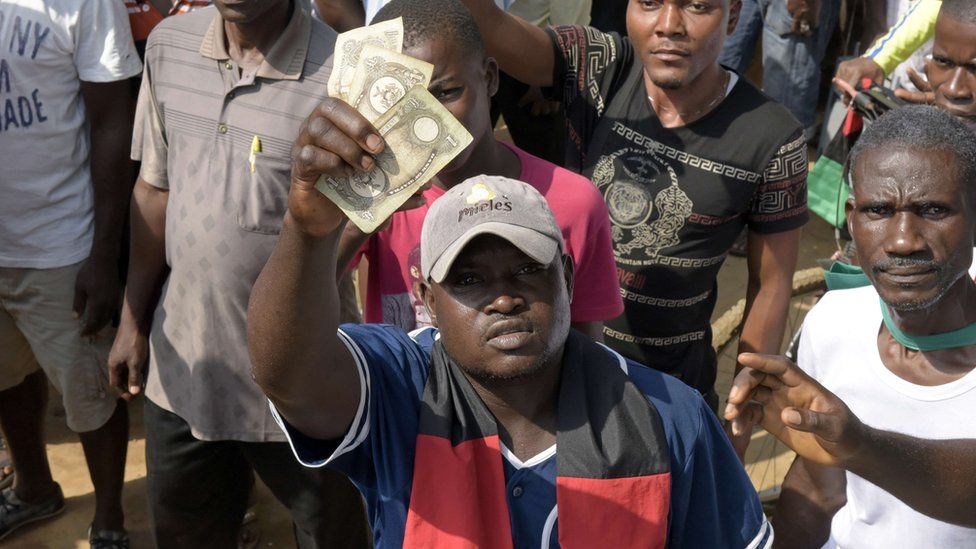 A man holds up Biafran banknotes in Aba, Nigeria - Wednesday 18 November 2015