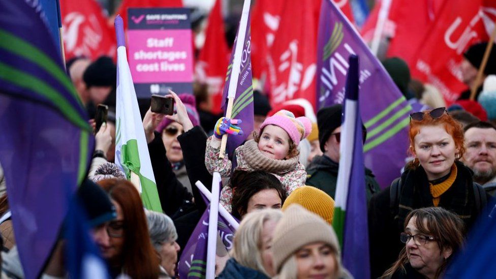 UNISON members take part in a rally outside Belfast City Hall during a major strike of around 170,000 public sector workers over the freezing of pay increases due to a breakdown of the region's power-sharing government, in Belfast, Northern Ireland, January 18, 2024.