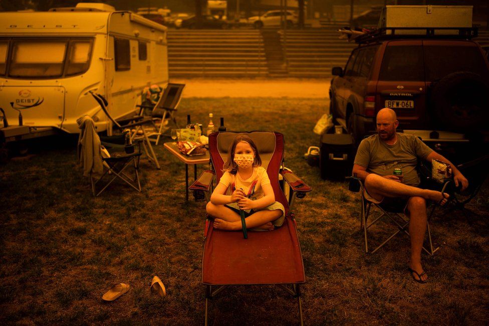 A family sit at a showground