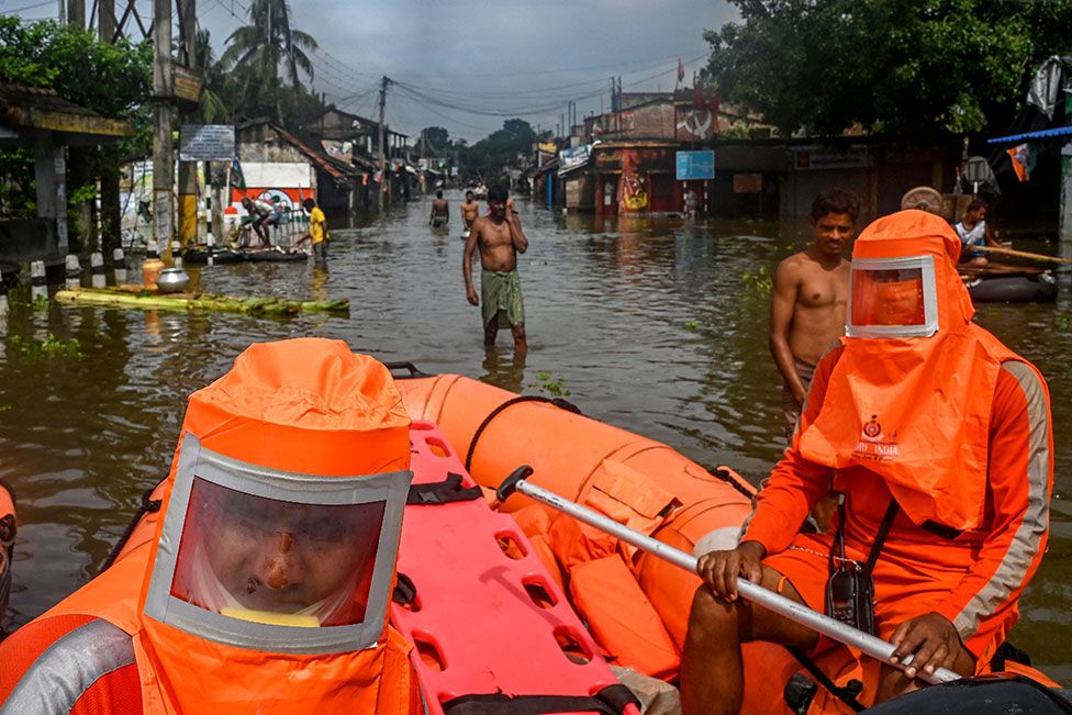 National Disaster Response Force (NDRF) personnel are seen on inflated boats in the flood-hit town of Amta in the Howrah district, India