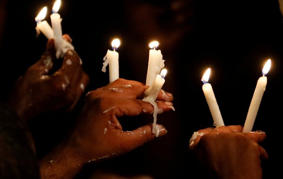 Supporters of the former Sri Lankan President Mahinda Rajapaksa, who leads the country's joint opposition, hold candles during an anti-government protest in Colombo, Sri Lanka