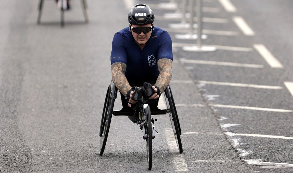 David Weir cruises over the finishing line in his wheelchair