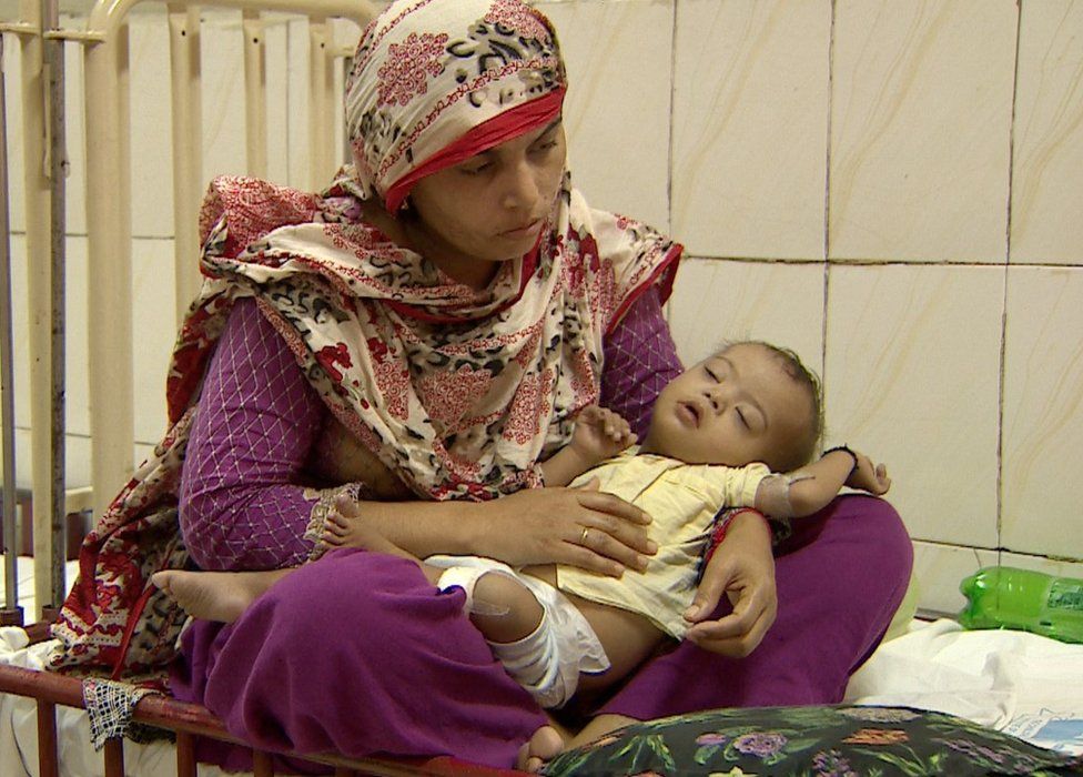 a mother cares for her child in a Pakistan hospital - September 2015