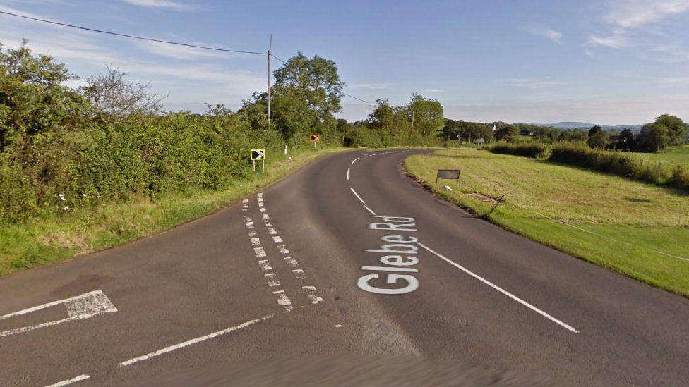 The woman was found injured at the junction of the Ballybollen Road and Glebe Road