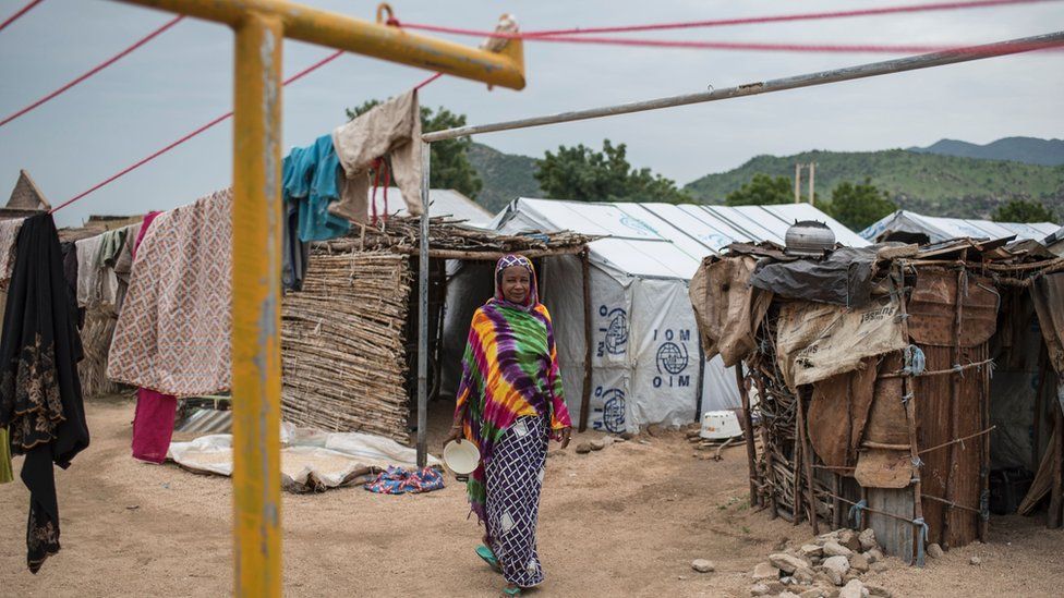 A woman walks through one of the Internally-Displaced People (IDP) camps in Gwoza, north-eastern Nigeria, on August 1, 2017.