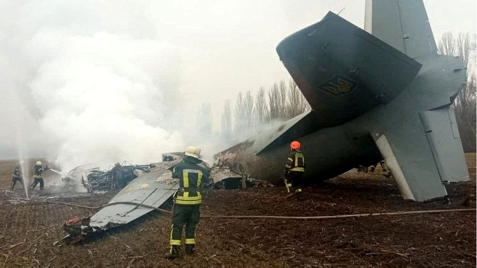 Rescuers work at the crash site of the Ukrainian Armed Forces" Antonov aircraft, which, according to the State Emergency Service, was shot down in Kyiv region, Ukraine, in this handout picture released February 24, 2022.