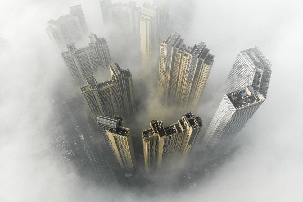 Aerial view of buildings surrounded by heavy fog