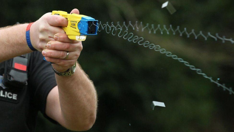 A generic image of a police officer using a Taser