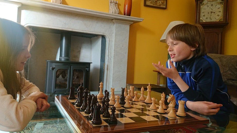 Freddy playing chess with his sister Josephine