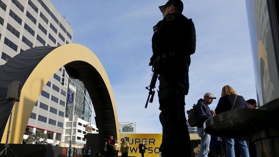 An armed police stands watch near a Super Bowl 50 attraction in down town San Francisco, California, on 4 February 2016.
