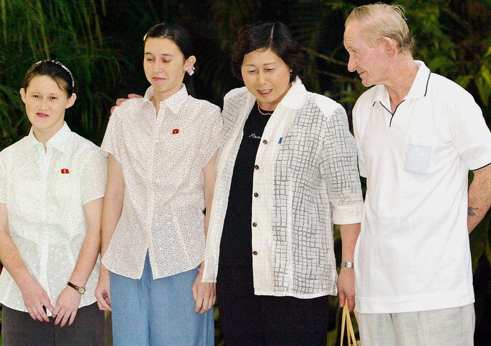 The Jenkins family smile awkwardly for photographers in Indonesia on 11 July 2004.