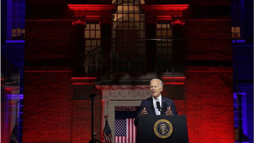 Biden speaking in Philly with a red background