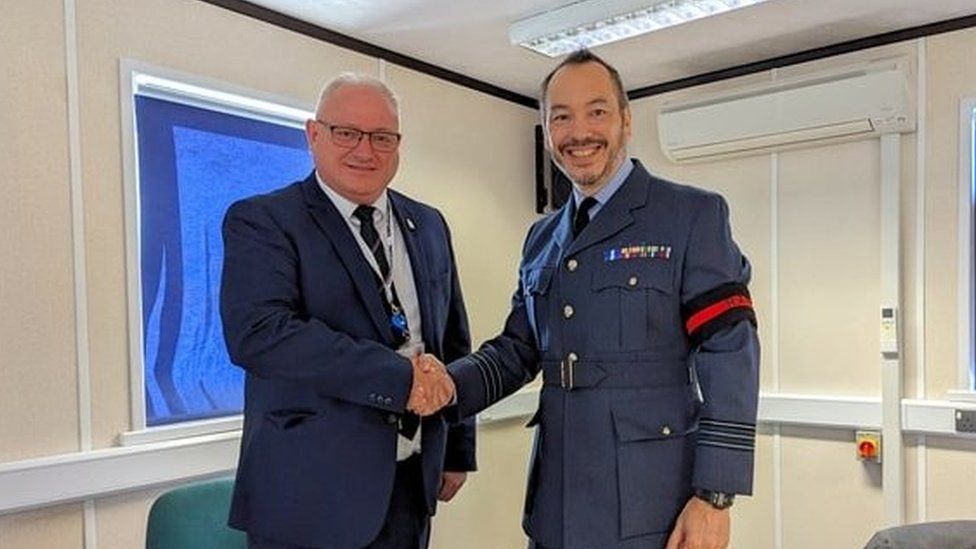 Leader of North Devon Council, Councillor Ian Roome, and Wing Commander Alex Drake sign North Devon Council's Armed Forces Covenant.