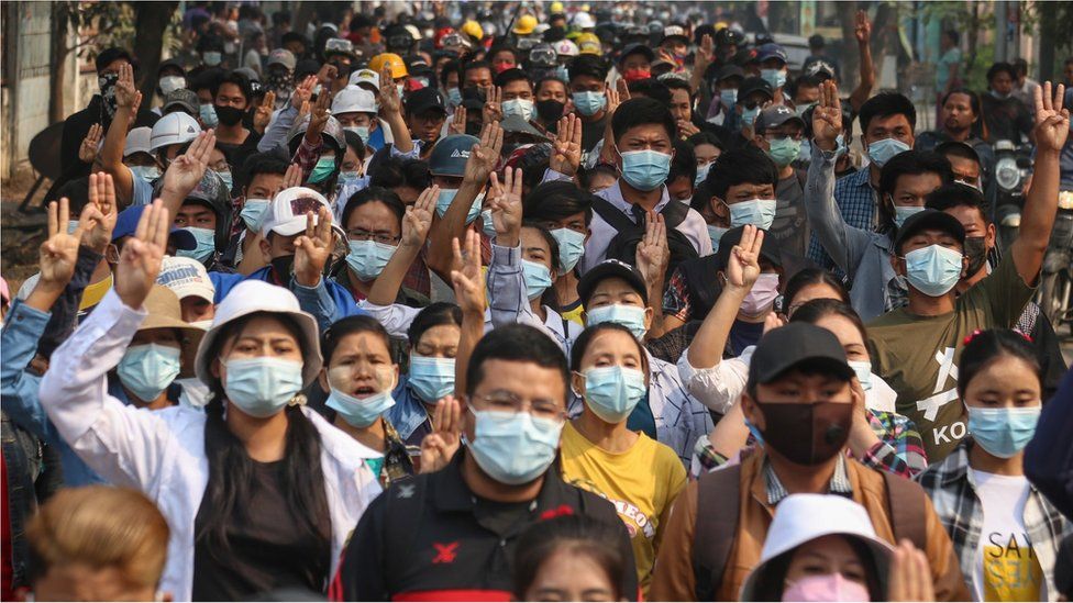 Demonstrators flash the three-finger salute during a protest against the military coup in Mandalay, Myanmar, 27 March 2021.