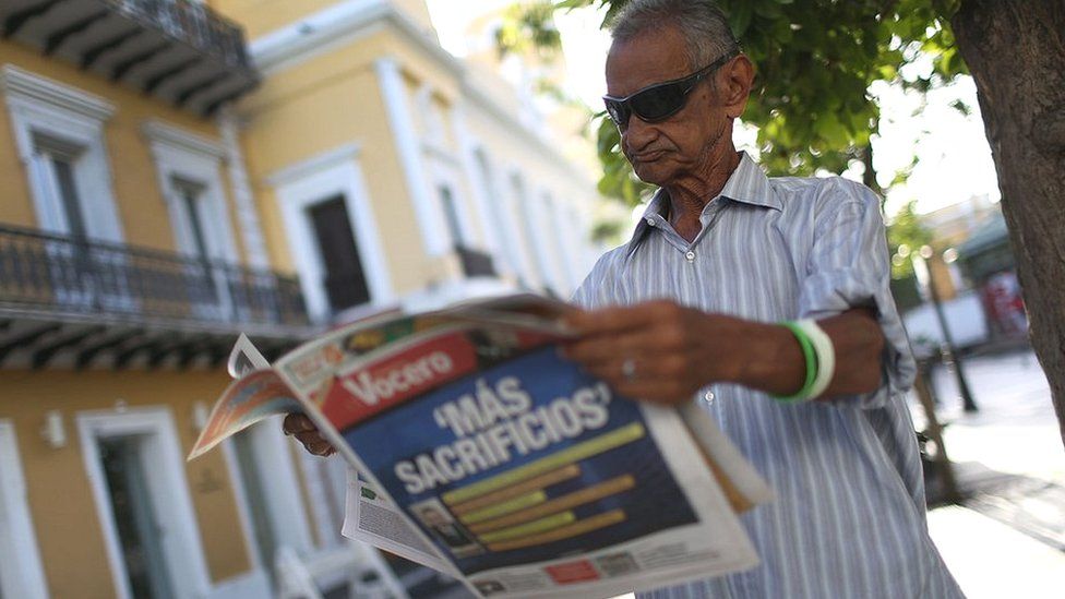Man reading newspaper in Puerto Rico