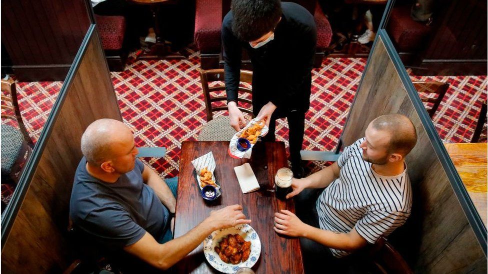 Two men eating in a Wetherspoons pub