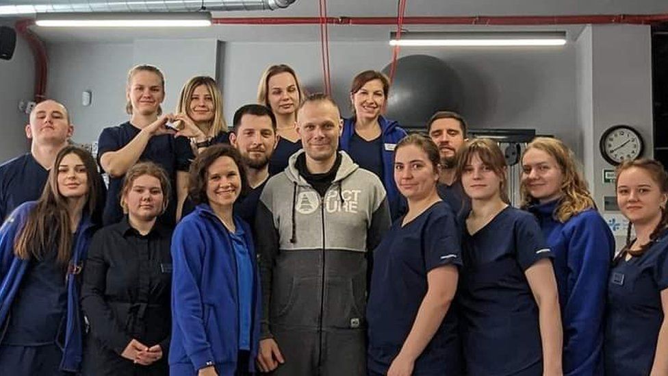 Vasyl Buchko with hospital staff who treated him for shrapnel in his leg in March 2024.