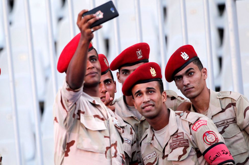 Egyptian military police soldiers take a selfie before the beginning of the match between ES Tunis, and Al Hilal during the Arab Club championship, at Borg Al Arab Stadium, in Alexandria, Egypt, 30 July 2017