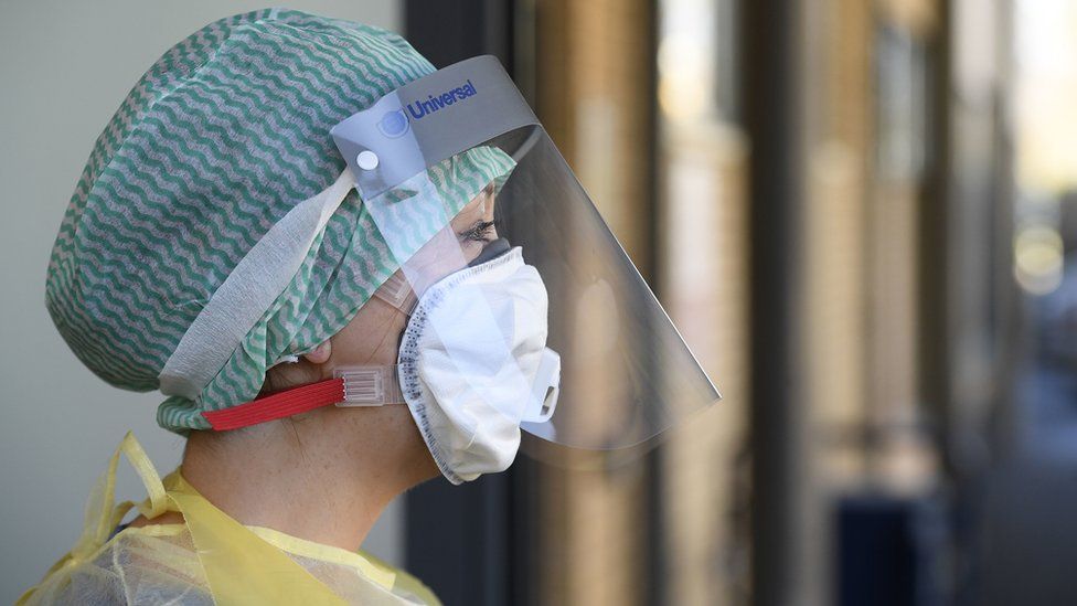 A healthcare worker wearing a protective mask