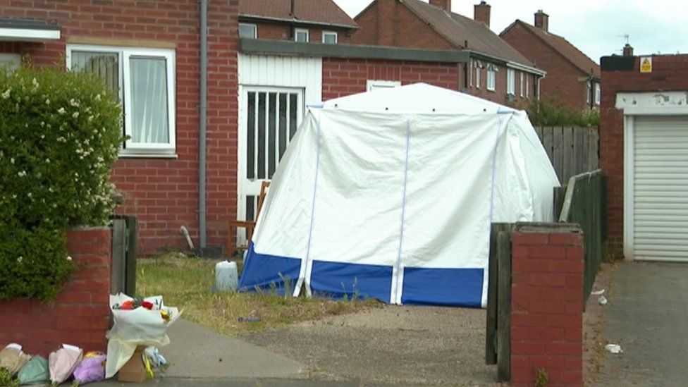 A forensic investigation tent was set up outside a house