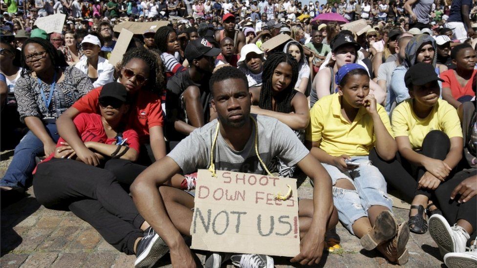 Students sit in protest during a mass demonstration on the steps of Jameson Hall at the University of Cape Town