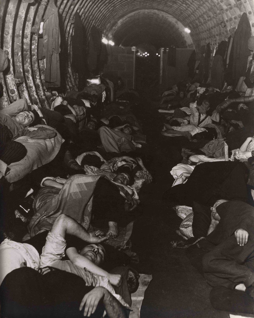 A photograph of people sleeping in an underground Blitz shelter