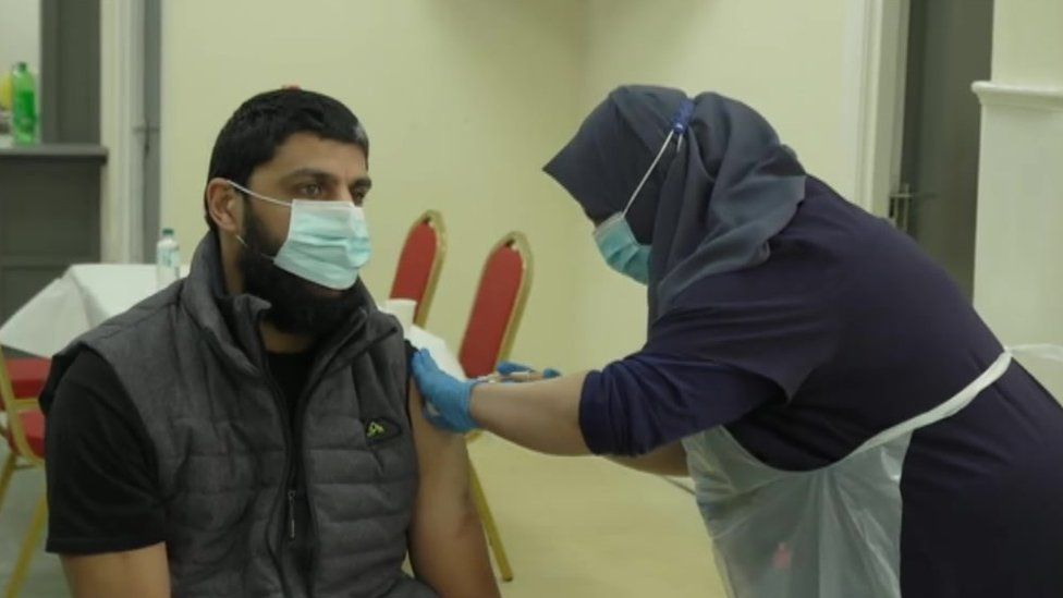 A patient receives a jab at the Al-Mustafa Centre